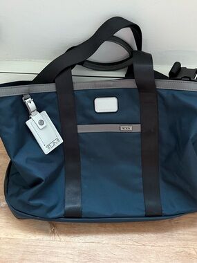 Tumi Navy Duffel Bag with Black Straps and Gray Trim